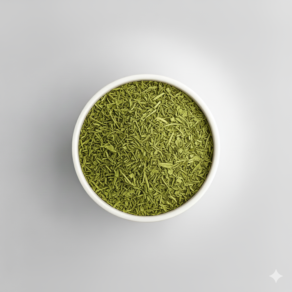 White bowl filled with green tea leaves on a gray background